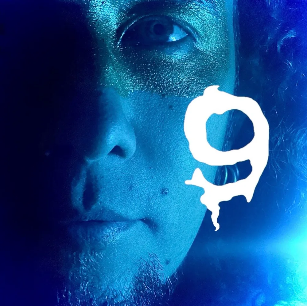 Portrait of Dario in blue light with his symbol