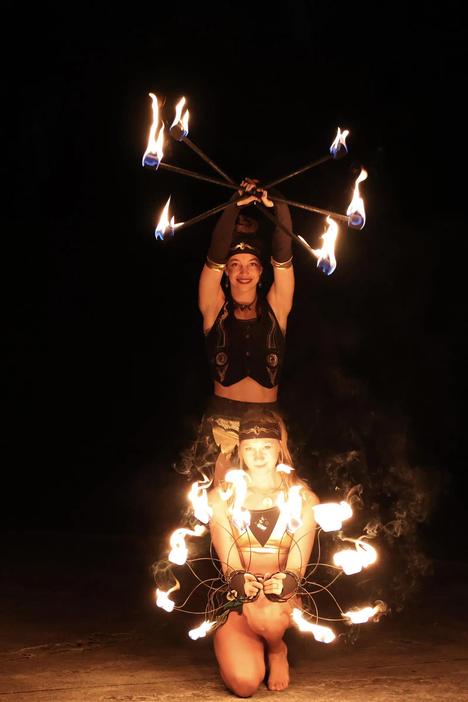 Duo with fire fans held overhead