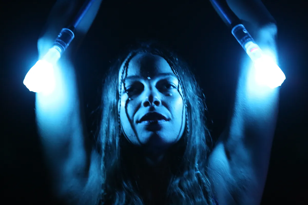 Mascha with LED props raised overhead